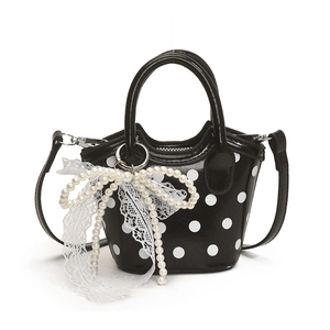 Polka dot mini tote bag for girls with pearl and lace bow charm on white background