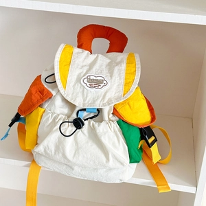 Macro shot of colorful kids backpack with contrasting pockets and cloud patch detail