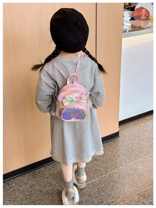 Close-up of pink iridescent kids backpack with sequin bow and colorful SUMMER letters