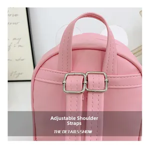 Close-up of pink PU leather backpack showing adjustable shoulder straps and silver metal buckle