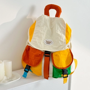 Detail of multi-color block kids backpack with buckle closure and crinkle texture fabric