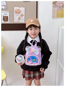 Girl wearing a purple quilted sequin backpack with a large colorful bow and SUMMER patch