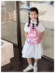 Pink toddler backpack with sequin bear and guitar design shown on a young girl