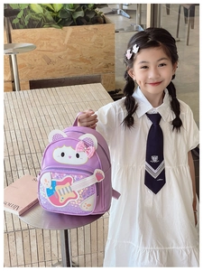 Close-up of cute purple cat backpack with sparkly sequin guitar pattern for little girls