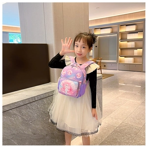 Detail view of purple mermaid backpack on a young girl in a modern interior setting