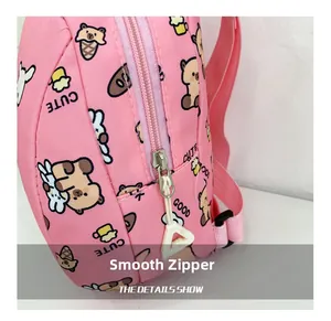 Close-up of a smooth white zipper on a pink cartoon backpack with cute animal patterns