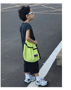 Outdoor look featuring a bright neon green drawstring crossbody bag with embroidered patches