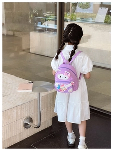 Detail of light purple toddler backpack featuring a cute cartoon cat playing the guitar