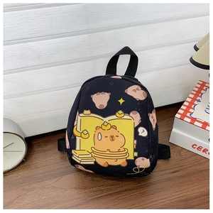 Close-up of black mini backpack with cartoon capybara prints on a wooden table