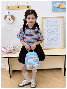 Toddler girl holding light blue sequin guitar backpack with cute cartoon animal print