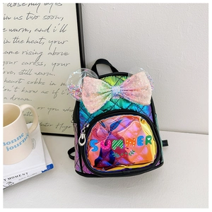 Detail of colorful sequin bow and rainbow quilted texture on children's fashion backpack