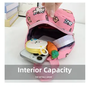 Internal capacity of the pink cartoon backpack showing space for a phone and makeup items