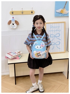 Cute blue cartoon cat backpack for kids with sequins guitar details shown on a model