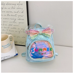 Detail of light blue sequin bow backpack with laser finish and quilted diamond pattern