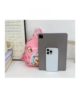 Size comparison of a pink Capybara school bag next to a smartphone and tablet device