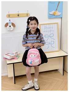 Pink toddler backpack with cute cat and guitar design carried by a little girl