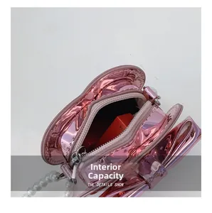 Macro detail of kids heart bag with internal capacity for lipstick and pearl strap