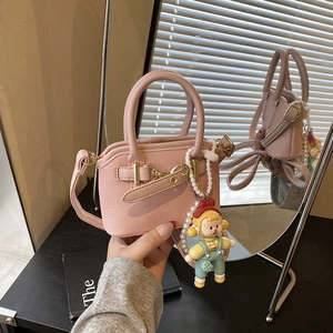 Pink mini crossbody shell bag with cute cartoon doll pendant and golden metal buckle