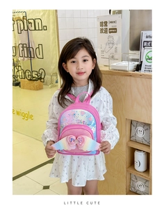 Detail of pink toddler backpack with sequin hearts, cute wings, and bow decoration
