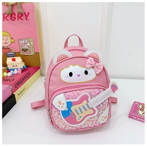 Detail of pink cartoon backpack with guitar motif, sequins and lace bow for toddlers