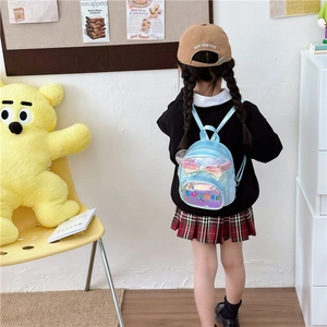 Blue kids backpack with sequin bow and transparent pocket worn by a young girl