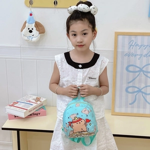 Blue kids backpack with Capybara print shown on a child in a home setting