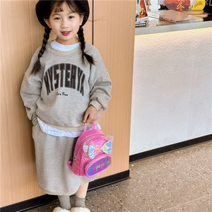 Pink sequin backpack with bow and quilted pattern for girls in an autumn outfit