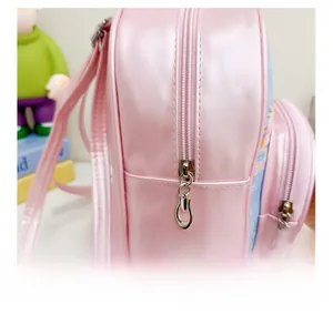 Detail shot of smooth silver zipper and glossy pink faux leather on kid's backpack