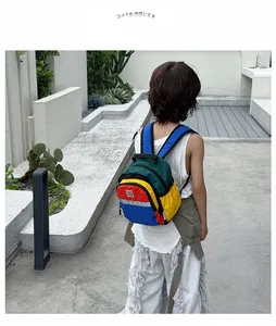 Outdoor view showing the back fit and adjustable straps of a colorful kids backpack
