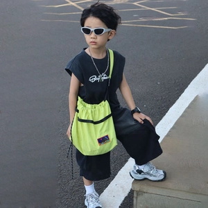 Kids streetwear set with black sleeveless vest, wide shorts and neon yellow crossbody bag