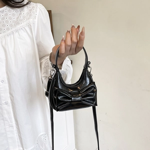 Elegant black bow-knot mini handbag in glossy pleated faux leather for daily style