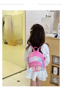 Pink kids sequin backpack with heart patterns, glitter bow, and colorful wings on a model