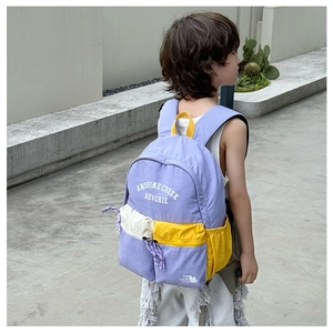 Detail view of large school backpack with stylish purple and yellow color blocking