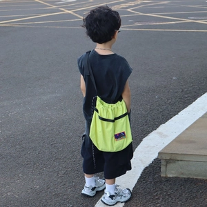 Kids bright yellow drawstring crossbody bag with adjustable straps for outdoor travel