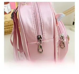 Detail view of smooth silver metal zippers and sequins on pink lace backpack