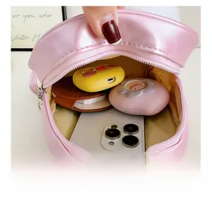 Detail view of the pink quilted toddler backpack showing interior space and pearl handle