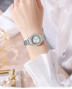 Elegant woman wearing silver GEDI watch with crystal bezel and metal link bracelet