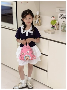 Detail of pink mini kids backpack with cute cartoon capybara and rabbit pattern