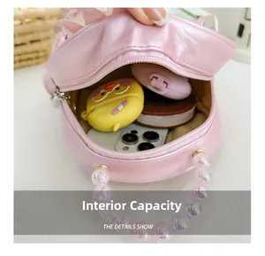 Internal view of pink sequined kids backpack showing storage space for phone and accessories