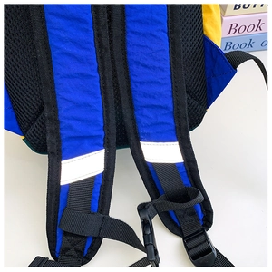 Detail of breathable mesh shoulder straps with reflective safety strips on kids backpack