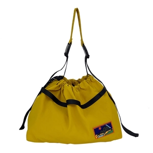 Mustard yellow nylon drawstring shoulder bag for kids with mountain patch and adjustable strap