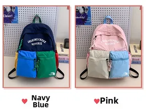 Detail of contrast color school bags with dual front pockets and letter print design