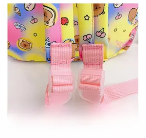 Detail showing adjustable pink shoulder strap with transparent buckle on capybara backpack