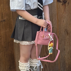 Cute pink mini handbag for girls with pearl charm, paired with a stylish school uniform set