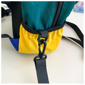 Detail of multi-color nylon backpack with plastic buckles and high-quality zippers