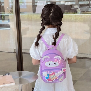 Cute purple sequin backpack with cartoon cat and guitar design worn by a child