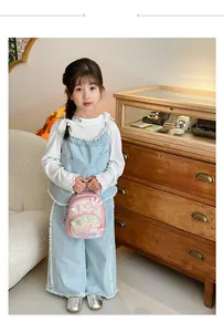 Pink sequin toddler backpack with lace butterfly and quilted design on child model