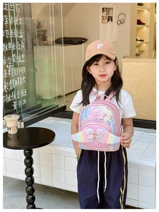 Detail of pink laser glitter backpack featuring gradient wings and rhinestone bow decoration