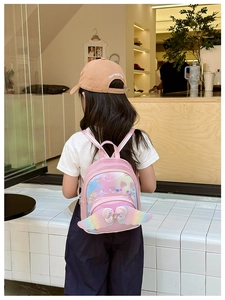 Close-up of pink toddler backpack with rainbow sequins heart and glittery wings detail
