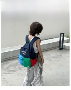 Outdoor back view of a child wearing the colorful patchwork nylon backpack